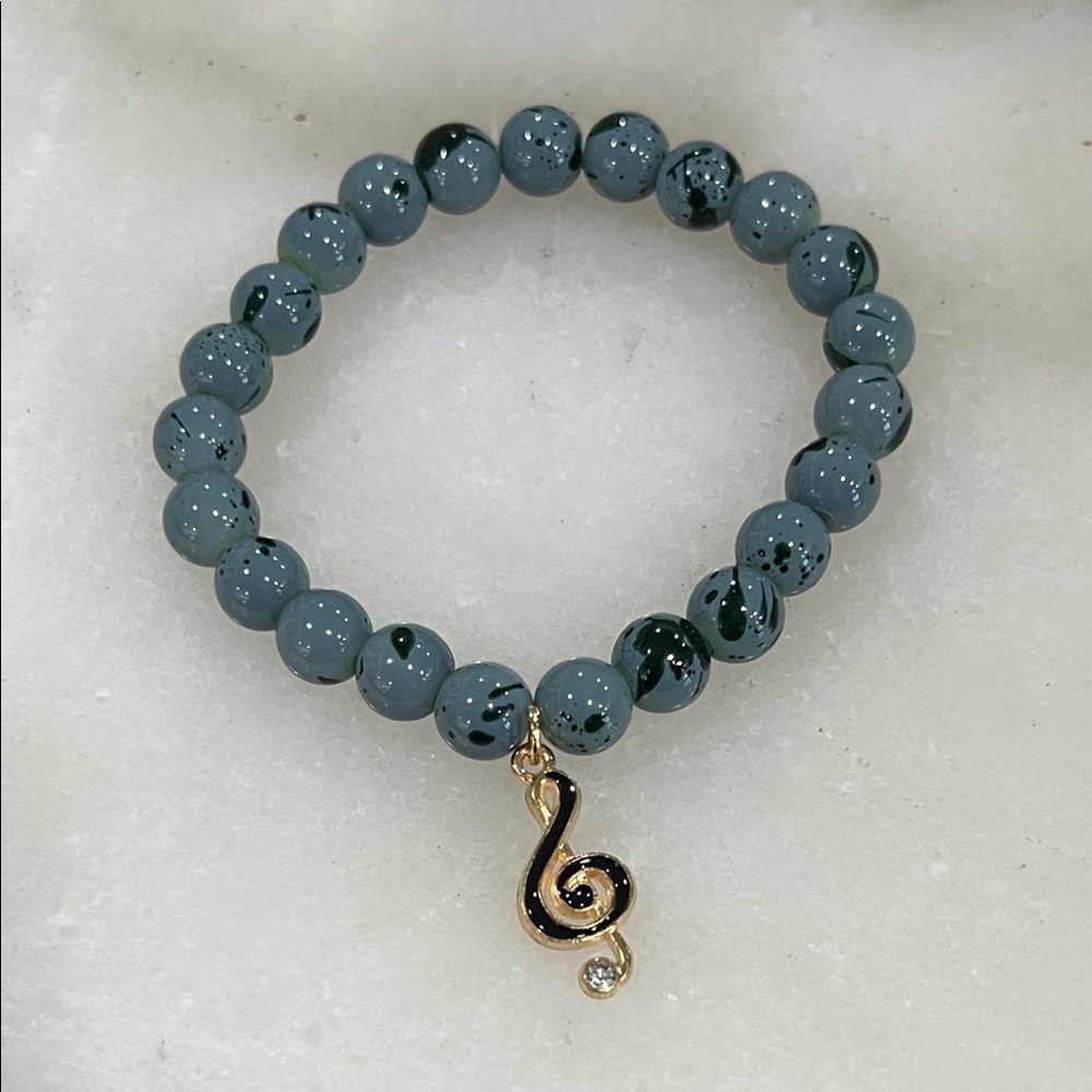 Elegant Blue Beaded Bracelet with Gold Treble Clef Charm